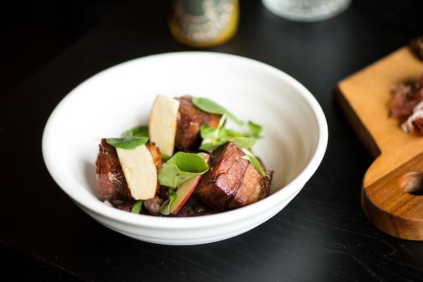 Tocino tapas, crispy pork belly, Pedro Ximenez, scarlet runner beans, creme fraiche, apple, watercress, and scallion. Photo credit- Mia Yakel.