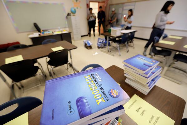 FILE - Notebooks are stacked on desks in a classroom at A.G. Hilliard Elementary School, Saturday, Sept. 2, 2017, in Houston. (AP Photo/David J. Phillip, File)