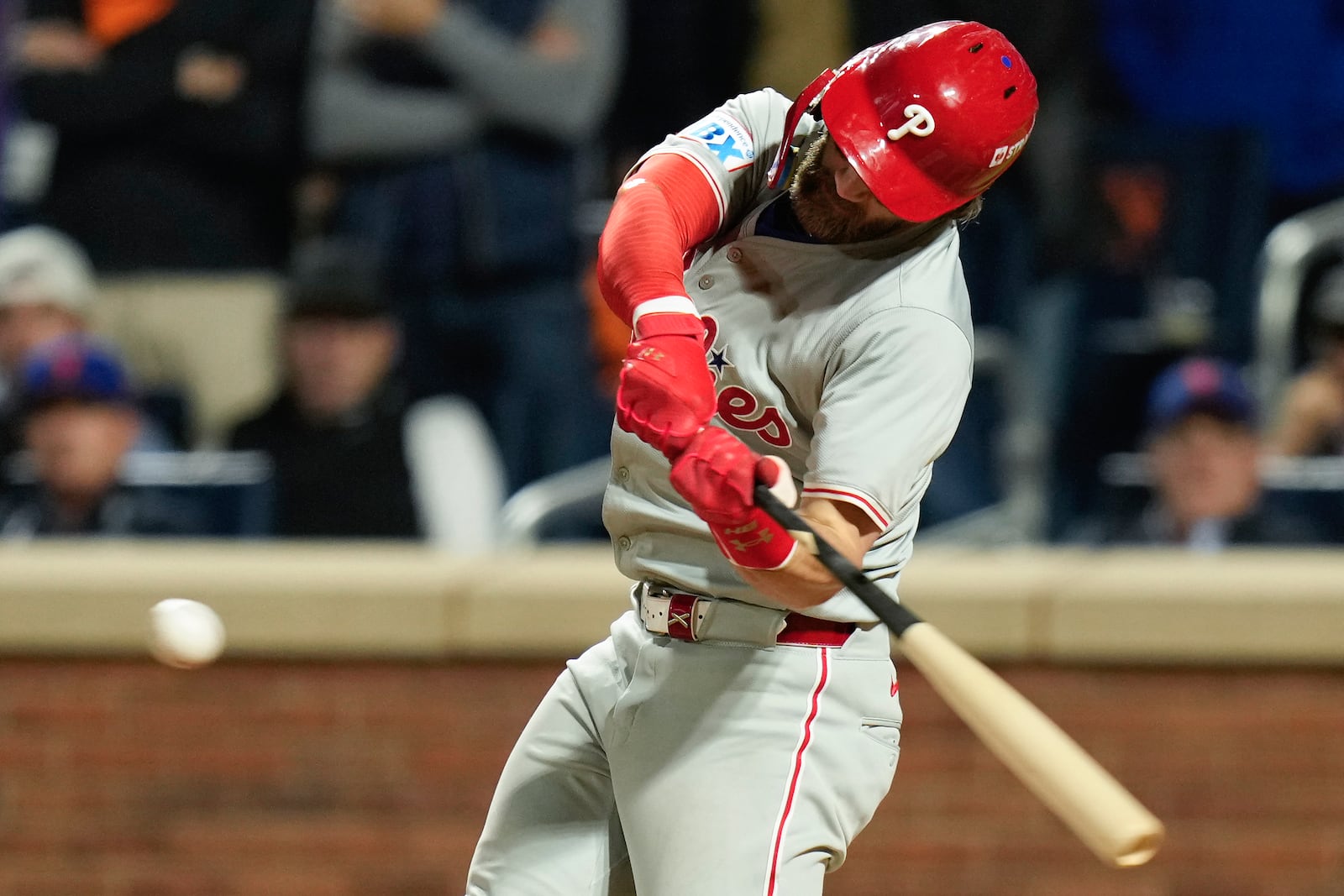 Philadelphia Phillies' Trea Turner (7) connects for an RBI single against the New York Mets during the eighth inning of Game 3 of the National League baseball playoff series, Tuesday, Oct. 8, 2024, in New York. (AP Photo/Seth Wenig)