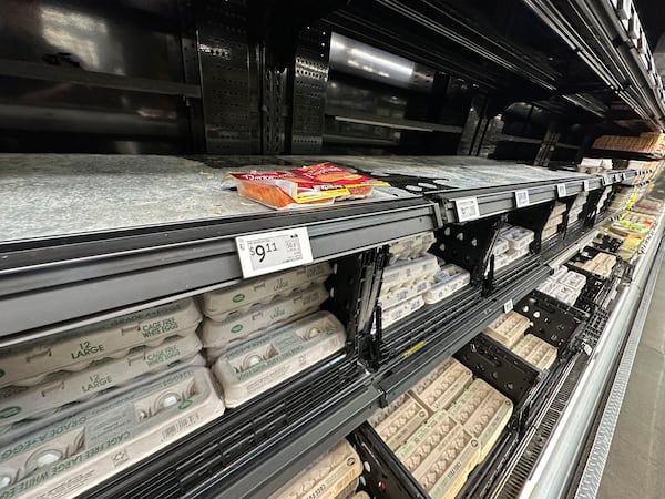 The price for cartons of 18 large eggs sits on the edge of an empty shelf in a refrigerated case inside a Walmart store Tuesday, March 18, 2025, in Englewood, Colo. (David Zalubowski/AP)