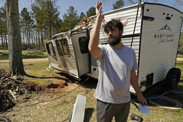 Cody McCoy of Biloxi, Miss., recalls the escape he and his family undertook, when an tornado flipped their bunkhouse camper Saturday in Tylertown, Miss., on Sunday, March 16, 2025. (AP Photo/Rogelio V. Solis)