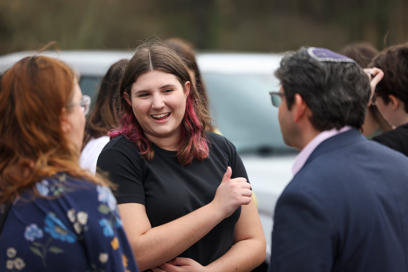 Pope High School student Hannah Foster talks with Rabbi Larry Sernovitz at the dedication for the Daffodil Project at Pope High School. Foster organized the project a year after antisemitic vandalism was found at the school. (Jason Getz / Jason.Getz@ajc.com)
