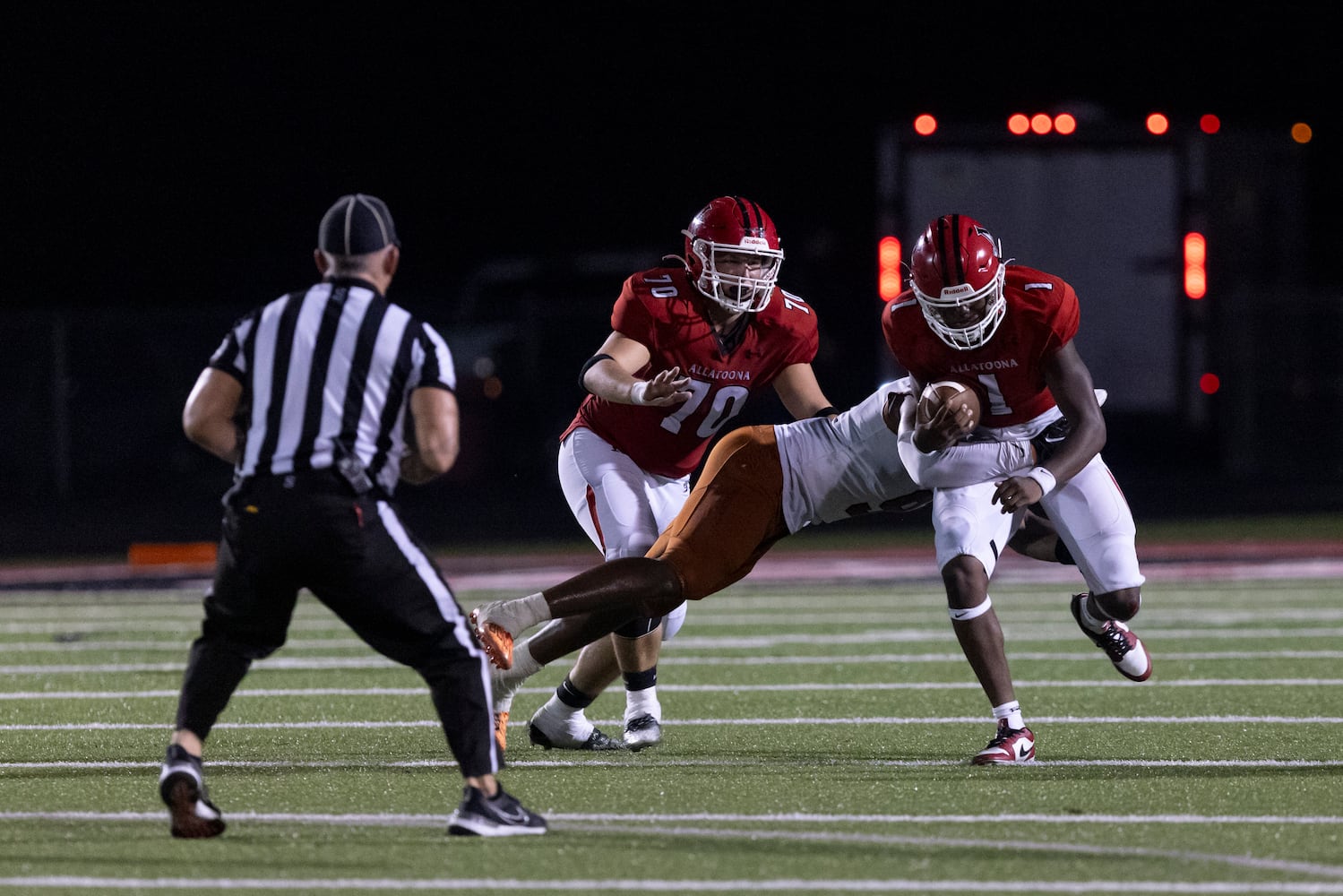 Allatoona’s Saadiq Tell (1) is tackled by Kell. (Photo/Jenn Finch)