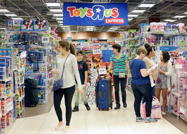 FILE - In this Friday, Nov. 25, 2016, file photo, shoppers shop in a Toys R Us store on Black Friday in Miami. Toys R Us, the pioneering big box toy retailer, announced late Monday, Sept. 18, 2017 it has filed for Chapter 11 bankruptcy protection while continuing with normal business operations. (AP Photo/Alan Diaz, File)