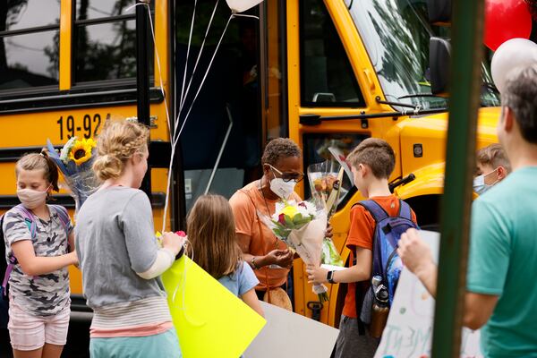 Atlanta Public Schools bus driver Alma Jennings received flowers and balloons from parents and students along her bus route on Monday, May 23, 2022. (Natrice Miller / natrice.miller@ajc.com)