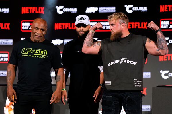 FILE - Mike Tyson, left, and Jake Paul, right, pose for photos during a news conference promoting their upcoming boxing bout, Thursday, May 16, 2024, in Arlington, Texas. (AP Photo/Sam Hodde, File)