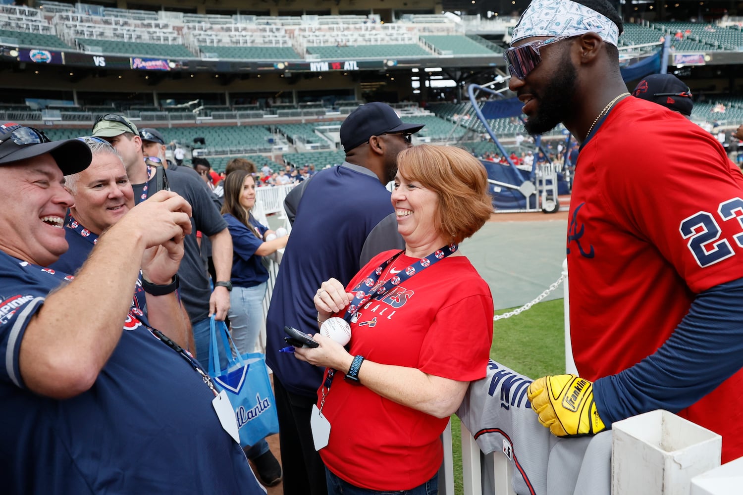 Atlanta Braves center fielder Michael Harris II (23) gets a photograph with a fan before the second game of the series between the Atlanta Braves and the New York Mets at Truist Park on Saturday, Oct. 1, 2022. Miguel Martinez / miguel.martinezjimenez@ajc.com 