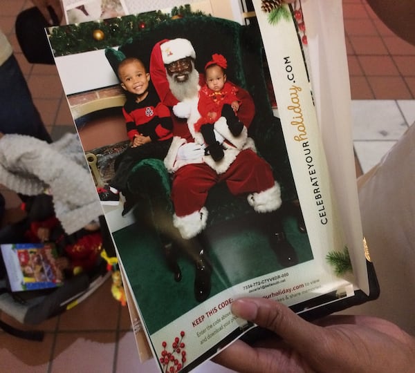 Kayson, 3, visits Santa Eddie for the second time, while 6-month-old Kailyn makes his acquintance.