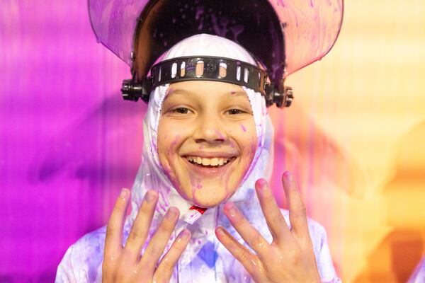 A boy smiles with paint on his face at Beat the Bomb in Atlanta on Saturday, October 15, 2022. The Brooklyn-based immersive escape room experience recently opened its Atlanta location. (Photo by Jenn Finch)