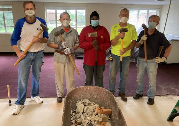 Members of Saint Luke's and Dodd-Sterling pose after tearing down a wall at the Southside church. (Courtesy of Daryl Moore)