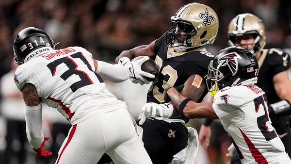 New Orleans Saints tight end Juwan Johnson (83) runs after a catch against Atlanta Falcons safety Justin Simmons (31) during the first half of an NFL football game, Sunday, Nov. 10, 2024, in New Orleans. (AP Photo/Gerald Herbert)