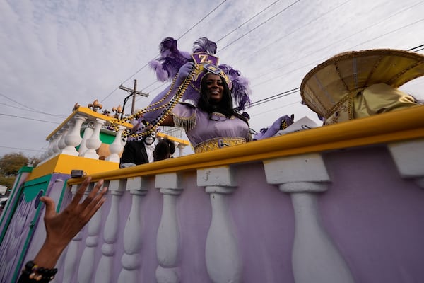 Revelers vie for throws during the Krewe of Zulu parade on Mardi Gras Day, Tuesday, March 4, 2025 in New Orleans. (AP Photo/Gerald Herbert)