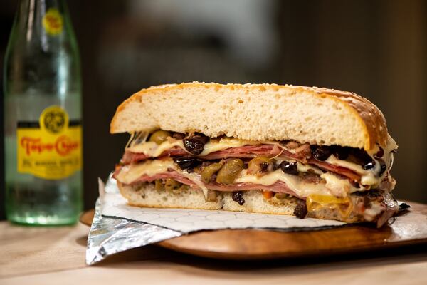 Muffuletta sandwich with Genoa, mortadella, ham, provolone, Swiss, and olives. Photo credit- Mia Yakel.