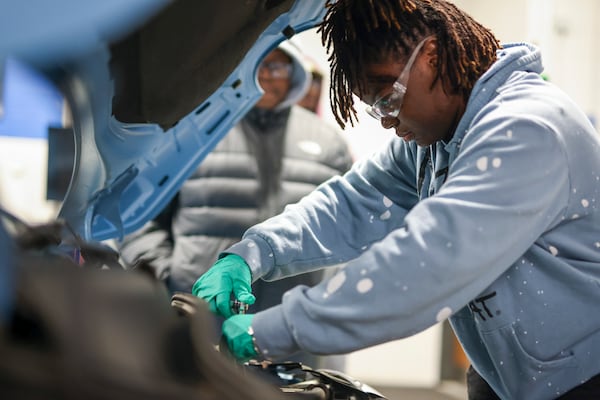 Automotive technology student Karissa Hodges of Snellville works on a Fiat 500e in the EV Automotive Lab at Gwinnett Technical College, Wednesday, Oct. 18, 2023, in Lawrenceville. Georgia's technical colleges are rebounding after a slump during the COVID-19 pandemic. (Jason Getz / Jason.Getz@ajc.com)