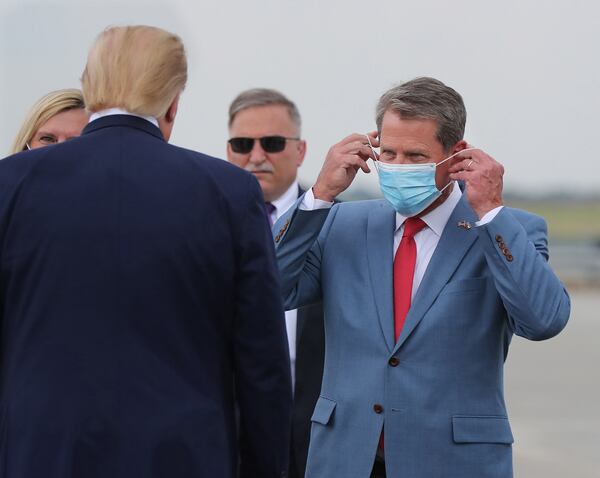 Georgia Gov. Brian Kemp, right, greets President Donald Trump as he visits Georgia to talk about an infrastructure overhaul at the UPS Hapeville hub at Hartsfield-Jackson International Airport in Atlanta on Wednesday, July 15, 2020. (Curtis Compton/Atlanta Journal-Constitution/TNS) 