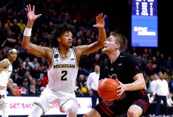 Michigan guard Kobe Bufkin (2) defends against Rutgers guard Cam Spencer (10) during the second half of an NCAA college basketball game in Piscataway, N.J.,Thursday, Feb. 23, 2023. (AP Photo/Noah K. Murray)