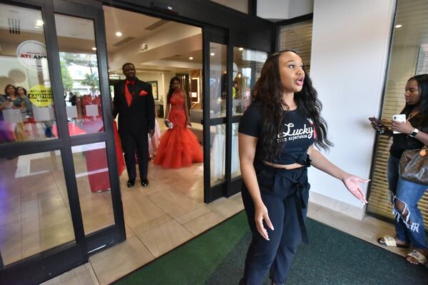 Keana Millar, founder and CEO of Lucky 7 Prom Experience, directs students before they walk on the red carpet at Holiday Inn Northlake on May 4, 2019. Her organization each year helps seven seniors, who would not otherwise be able to afford it, attend their high school prom. HYOSUB SHIN / HSHIN@AJC.COM