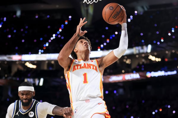 Atlanta Hawks forward Jalen Johnson (1) goes up to shoot against Milwaukee Bucks forward Bobby Portis, left, during the first half of a semifinal game in the NBA Cup basketball tournament Saturday, Dec. 14, 2024, in Las Vegas. (AP Photo/Ian Maule)