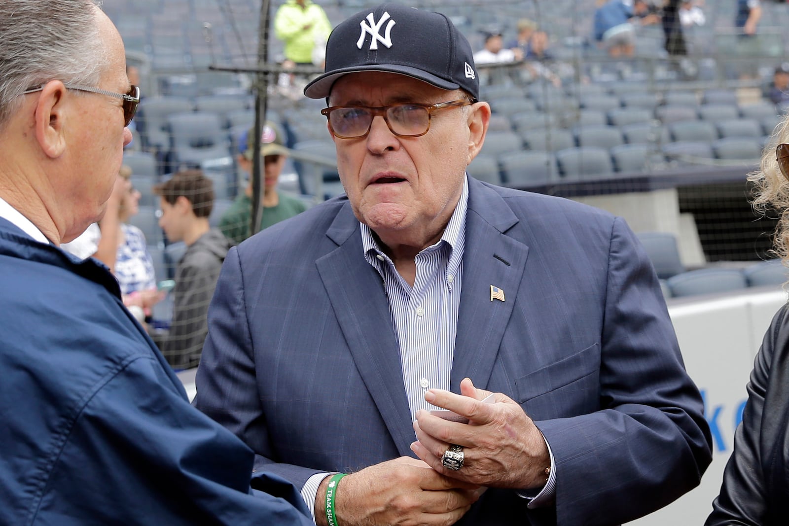 FILE — Rudy Giuliani, wearing one of his Yankees' championship rings, talks with people on the field before the game between the New York Yankees and the Houston Astros at Yankee Stadium, May 28, 2018 in New York. (AP Photo/Seth Wenig, File)