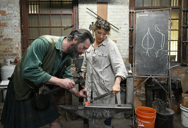 Mark Johnstone Hopper (left) works on a leaf as his partner Jessica Collins helps at the studio, Goat n Hammer. Hyosub Shin / Hyosub.Shin@ajc.com