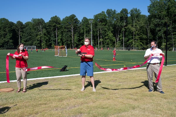 Dunwoody City Council members Stacey Harris (lfar left), John Heneghan and Tom Lambert at the new athletic fields.