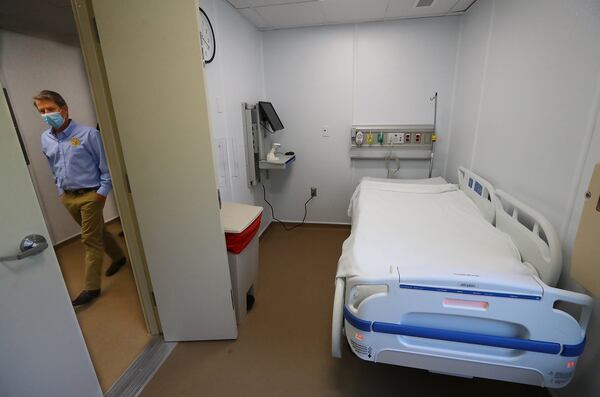 Gov. Brian Kemp passes by a patient room while touring the temporary medical pod that has been placed at the North Campus of Phoebe Putney Health System on Tuesday, May 5, 2020, in Albany. The pod is scheduled to begin operations on Wednesday, May 6, housing 24 beds to treat non-critical COVID-19 patients. (CURTIS COMPTON / ccompton@ajc.com)