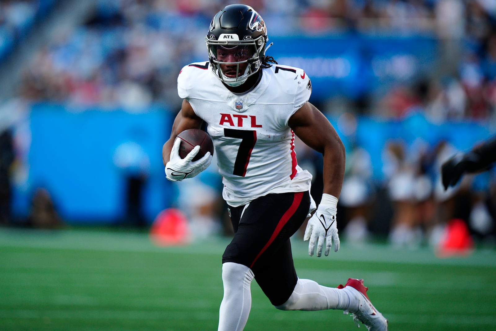 Atlanta Falcons running back Bijan Robinson (7) runs the ball in the first half of an NFL football game against the Carolina Panthers in Charlotte, N.C., Sunday, Oct. 13, 2024. (AP Photo/Jacob Kupferman)