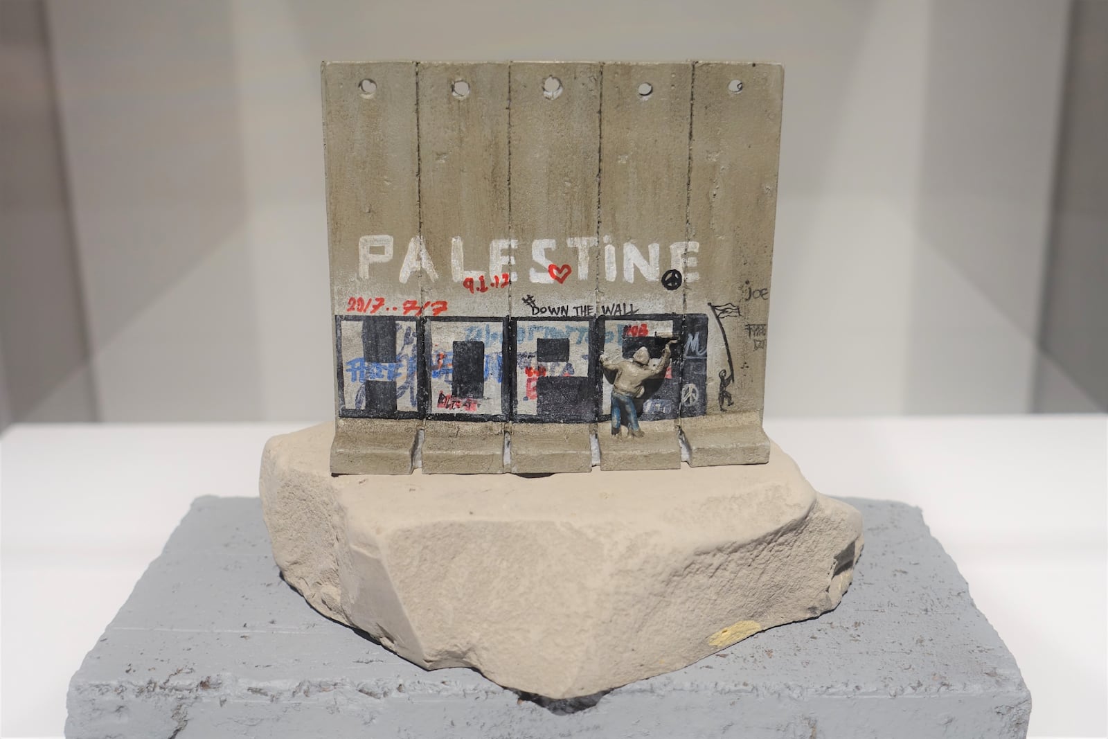 Banksy's protest-stay The Walled Off Hotel in the West Bank, for a time offered kitschy souvenirs painted by Palestinian artists for sale in its gift shop. Three of those tchotchkes are on display in "Without Limits." Originally sold for about $60 dollars at the Walled Off Hotel, the souvenirs are now available for resale at steep prices on sites like eBay.  
Courtesy of Lola Scott Art for SEE Global Entertainment