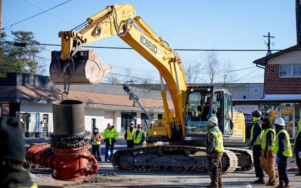 On Thursday, DeKalb County watershed crews lower equipment into a hole on Clairmont Road, where a water main broke three days earlier.