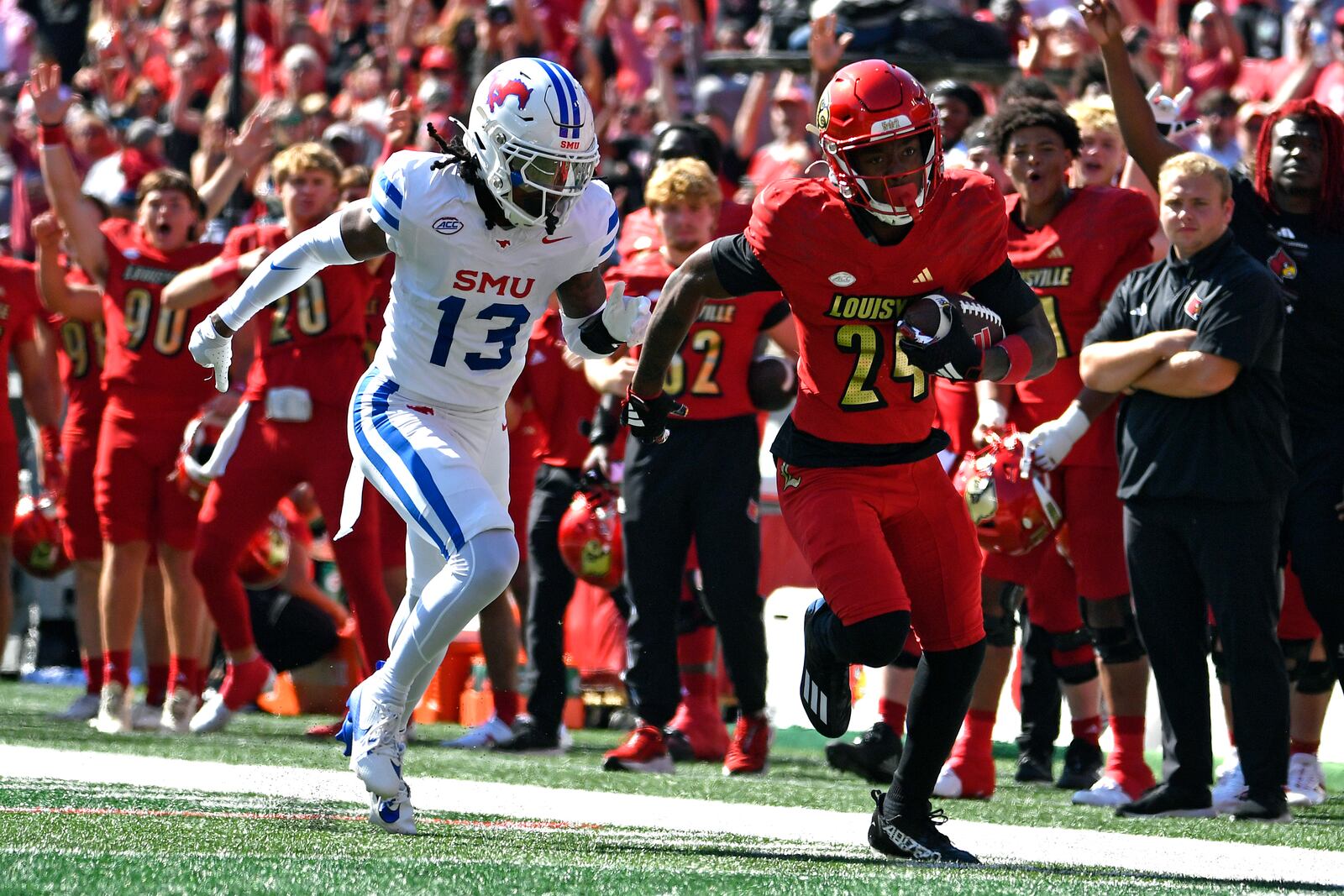 SMU cornerback Jaelyn Davis-Robinson (13) attempts to run down Louisville wide receiver Ahmari Huggins-Bruce (24) during the first half of an NCAA college football game in Louisville, Ky., Saturday, Oct. 5, 2024. (AP Photo/Timothy D. Easley)