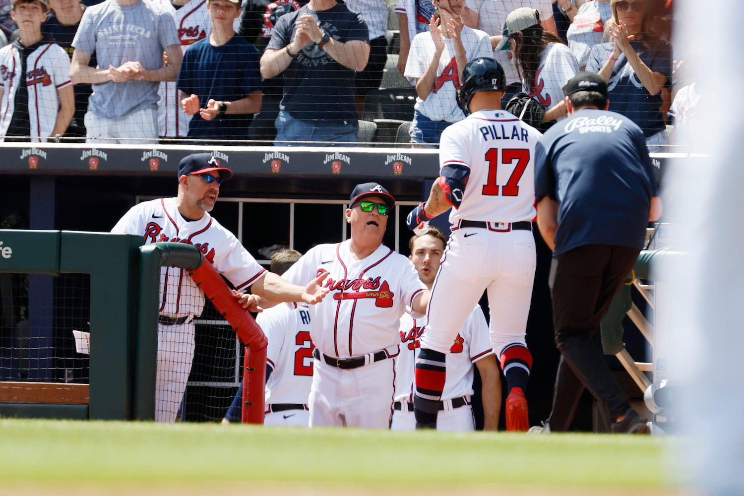 Braves left fielder Kevin Pillar is congratulated by manager Brian Snitker (43)  as he walks to the dugout after hitting a solo home run during the fifth inning against the Houston Astros at Truist Park, Sunday, April 23, 2023, in Atlanta. 
 Miguel Martinez / miguel.martinezjimenez@ajc.com 