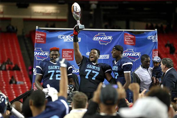  Cedar Grove's Netori Johnson (72), Justin Shaffer (77) and Jelani Woods (17) celebrate their win against Greater Atlanta Christian during the Class AAA state championship game Friday at the Georgia Dome. (Jason Getz/Special)