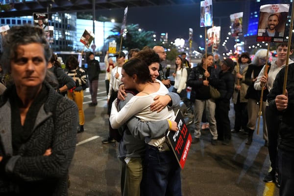 Relatives and friends of people killed and abducted by Hamas and taken into Gaza, take part in a demonstration in Tel Aviv, Israel, Wednesday, Jan. 15, 2025. (AP Photo/Ohad Zwigenberg)