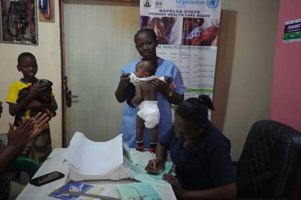 A health worker prepares a child to be administered the malaria vaccine R21/Matrix-M at the Health Centre in Yenagoa, Nigeria, Tuesday, Dec. 10, 2024. (AP Photo/Sunday Alamba)