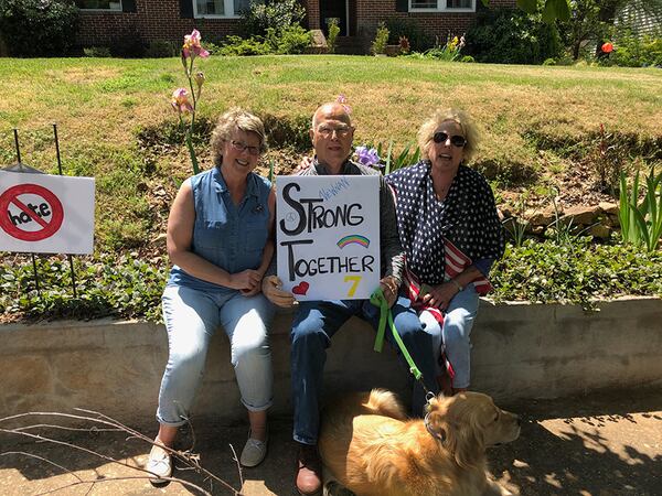 Newnan residents (from left) Jenny Lewis, Jack McBride and Chris McBride show their anti-hate signs ahead of Saturday’s planned rally by neo-Nazis.