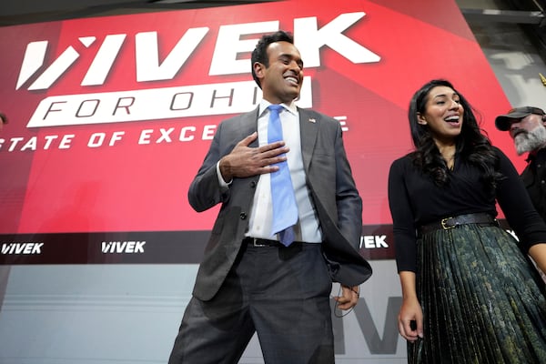 Vivek Ramaswamy, center, and Apoorva Ramaswamy, right, smile with supporters after an event announcing his candidacy for Ohio governor, Monday, Feb. 24, 2025, in West Chester Township, Ohio. (AP Photo/Kareem Elgazzar)