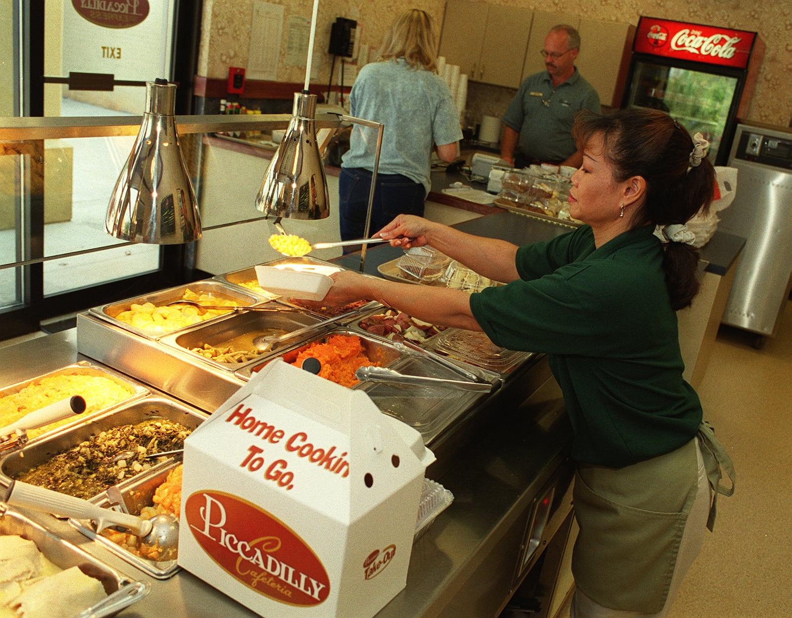 Seewan Cain prepares meals in thee Piccadilly Express section of the Marietta location in this file photo. 