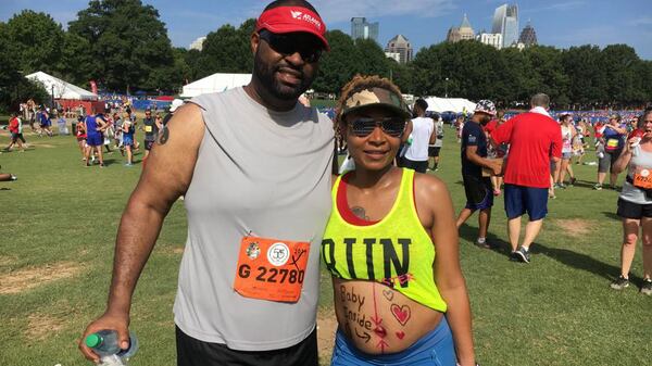 Tai Glover-Slaton runs the 2019 AJC Peachtree Road Race four-and-a-half months pregnant with her husband Antraveous Slaton.