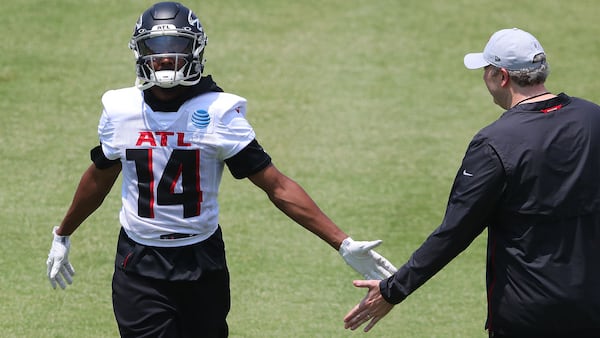 Falcons wide receiver Russell Gage (14), wearing a new jersey number, is congratulated by coach Arthur Smith after catching a pass during OTAs Tuesday, May 25, 2021, at the team training facility in Flowery Branch. (Curtis Compton / Curtis.Compton@ajc.com)