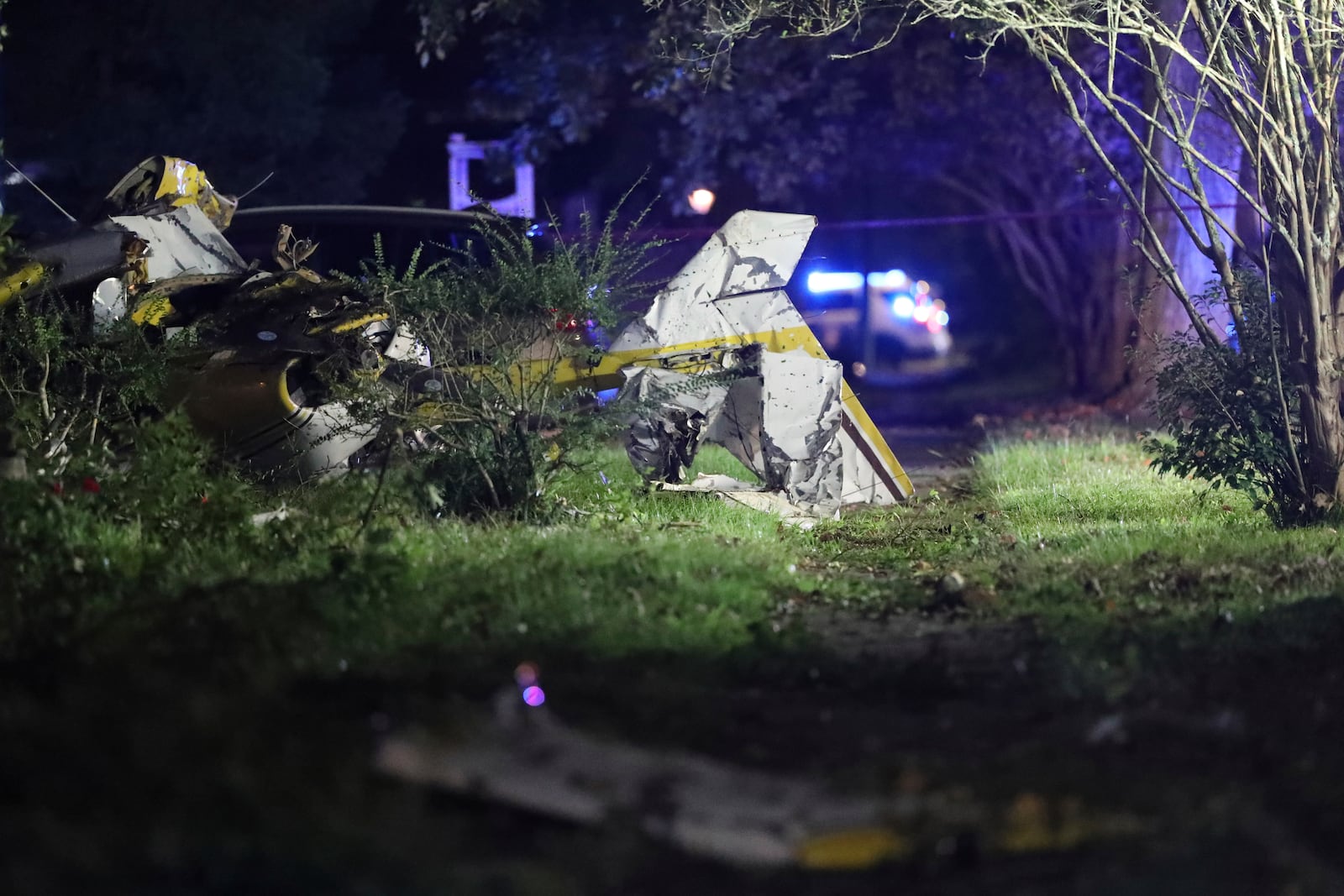 A twisted and mangled Cessna rests in the front yard of a home in Savannah, Ga., Sunday, Oct. 13, 2024. (Richard Burkhart/Savannah Morning News via AP)