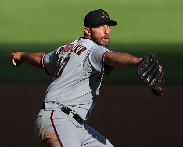 Arizona Diamondbacks starting pitcher Madison Bumgarner delivers during the sixth inning against the Braves in the second game of a doubleheader Sunday, April 25, 2021, at Truist Park in Atlanta. Bumgarner did not allow a hit, but MLB rules to not consider the no-hitter official because the game went only seven innings. (Curtis Compton / Curtis.Compton@ajc.com)