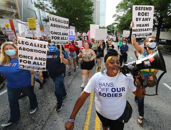 050322 Atlanta: Dozens of protesters march from Centennial Olympic Park to the Georgia Capitol during a rally to defend the right to abortion on Tuesday, May 3, 2022, in Atlanta.    “Curtis Compton / Curtis.Compton@ajc.com”