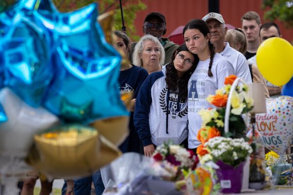 (L-R) Maya Soto and Lana Kriskovic comfort each other at a vigil at Jug Tavern Park in Winder on Friday, Sept. 6, 2024. A 14-year-old Apalachee High School student is accused of shooting and killing two fellow students and two teachers and injuring nine others at the Barrow County high school on Wednesday.