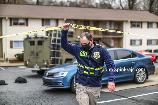 Bahan Rich, the GBI special agent in charge of the Atlanta Regional Office, walks the crime scene at the Concord Chase Apartments on Thursday morning. The agency is investigating a shooting at the request of the Cobb County Sheriff's Office.