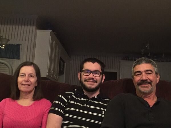 A suicide attempt in 2011 left Chase Gottlieb (center) with a severe brain injury. He is pictured recently with his parents, Wendy and Randy Gottlieb, at their home in Lilburn. CONTRIBUTED