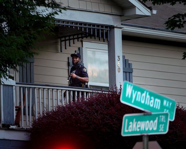 An Atlanta police officer investigates a fatal shooting Sunday at a home on Wyndham Way in the Lakewood neighborhood of southeast Atlanta.