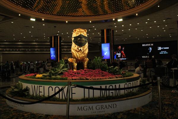 An MGM lion in the lobby of the MGM Grand shares a mask message with visitors.