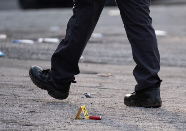 Atlanta police investigate a shooting scene on Joseph E. Boone Boulevard.