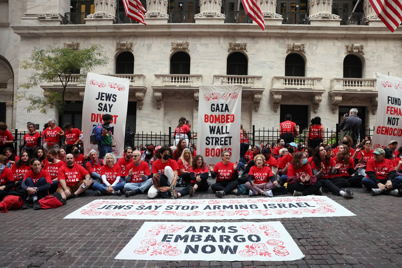 Anti-Israel protesters occupy an area in front of the New York Stock Exchange, Monday, Oct. 14, 2024, in New York. (AP Photo/Yuki Iwamura)