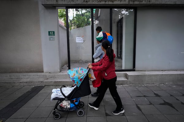 Residents pass by the shuttered Text&Image bookstore in Shanghai, Oct. 9, 2024. (AP Photo/Andy Wong)